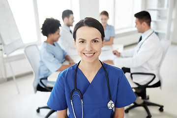 Image showing happy doctor over group of medics at hospital