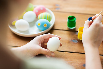 Image showing close up of woman coloring easter eggs