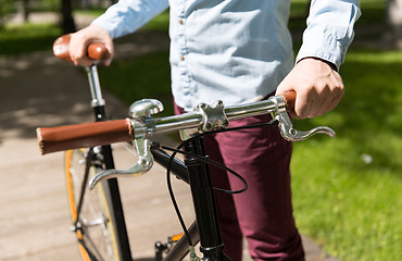 Image showing close up of young hipster man with fixed gear bike