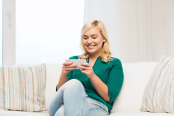 Image showing happy woman with smartphone at home