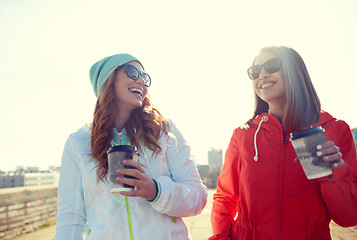 Image showing happy teenage girls with coffee cups on street