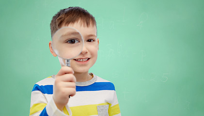 Image showing happy little boy looking through magnifying glass