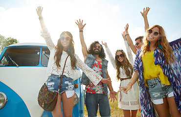 Image showing smiling hippie friends having fun over minivan car