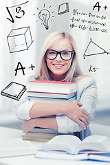 Image showing student with stack of books and doodles