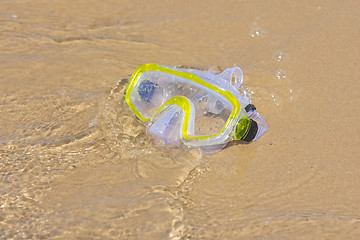 Image showing The swimming mask lying on the sand at the waters edge