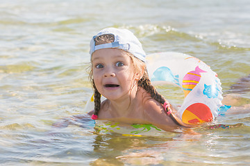 Image showing Funny four-year girl floats with a circle in the water