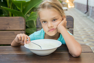 Image showing Six year old girl does not want to eat porridge for breakfast