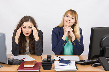 Image showing The situation in the office - the girl was very tired from his colleagues