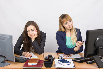 Image showing Two girls looking at computer screens, one joy, the second upset