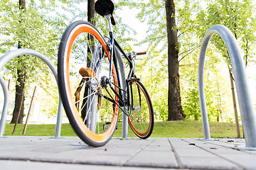 Image showing close up of bicycle locked at street parking