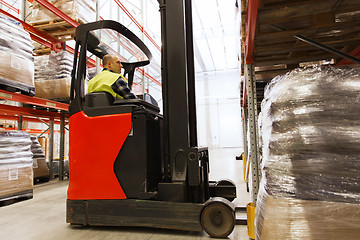 Image showing man on forklift loading cargo at warehouse