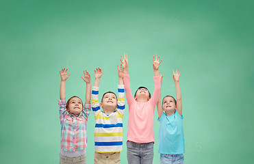 Image showing happy children celebrating victory over green