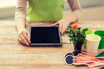 Image showing close up of woman or gardener with tablet pc