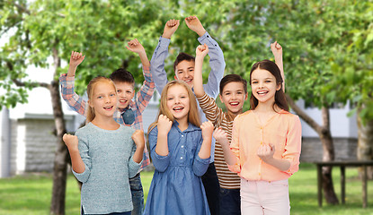 Image showing happy children celebrating victory over backyard