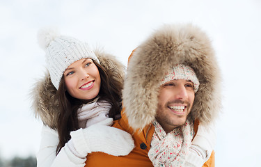 Image showing happy couple having fun over winter background