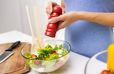 Image showing close up of woman cooking vegetable salad at home