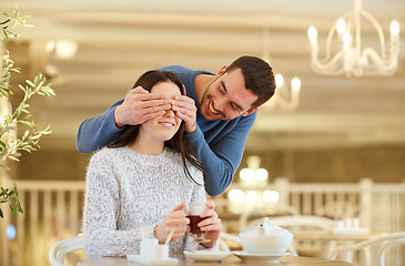 Image showing happy couple drinking tea at cafe