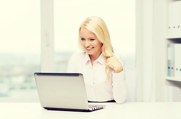 Image showing smiling businesswoman or student with laptop