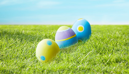 Image showing close up of colored easter eggs on grass