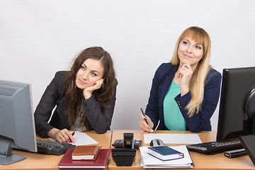 Image showing The situation in the office - two women dreaming, sitting at a desk