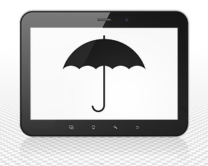 Image showing Protection concept: Tablet Pc Computer with Umbrella on display