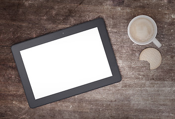 Image showing Tablet touch computer gadget on wooden table