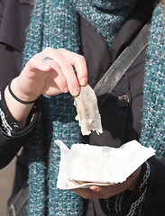 Image showing Dutch woman is eating typical raw herring