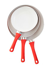 Image showing Set of three frying pans, red