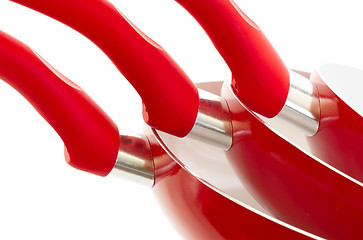 Image showing Set of three frying pans, red