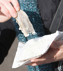 Image showing Dutch woman is eating typical raw herring