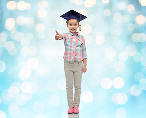 Image showing happy girl in bachelor hat showing thumbs up