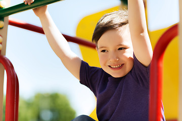 Image showing happy little boy climbing on children playground