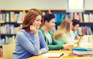 Image showing happy student girl reading books in library