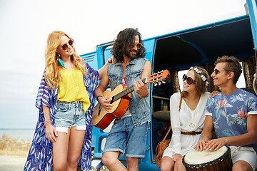 Image showing happy hippie friends playing music over minivan