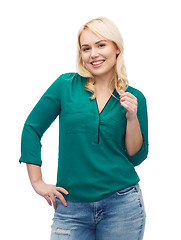 Image showing smiling young woman in shirt and jeans