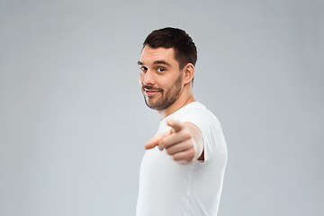 Image showing man pointing finger to you over gray background