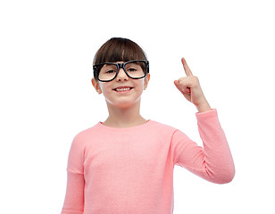 Image showing happy little girl in eyeglasses pointing finger up