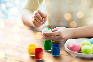 Image showing close up of woman hands coloring easter eggs