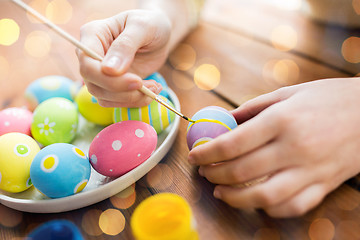 Image showing close up of woman hands coloring easter eggs