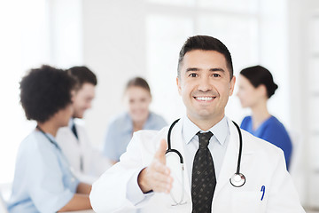 Image showing happy doctor over group of medics at hospital