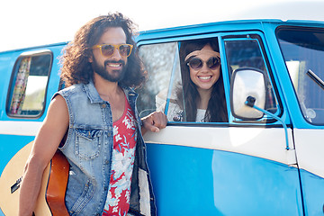 Image showing smiling young hippie friends over minivan car