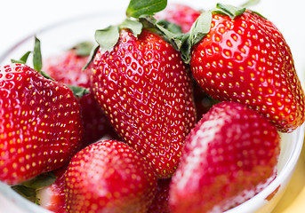 Image showing close up of ripe red strawberries over white