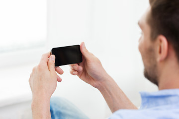 Image showing close up of man with smartphone at home