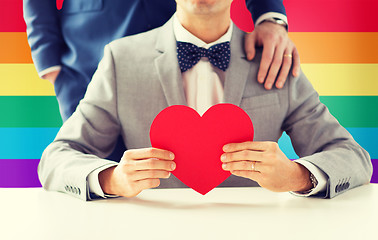 Image showing close up of male gay couple with red heart