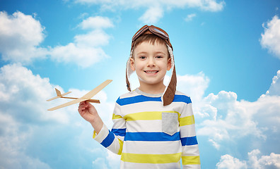 Image showing happy little boy in aviator hat with airplane