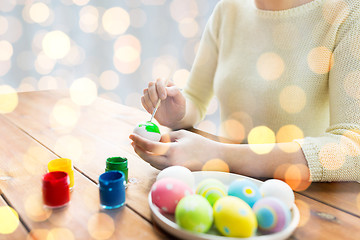 Image showing close up of woman hands coloring easter eggs