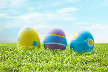 Image showing close up of colored easter eggs on grass