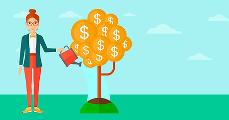 Image showing Woman watering money tree.