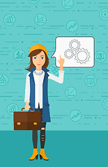 Image showing Business woman pointing at cogwheels.