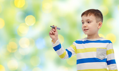 Image showing little boy drawing or writing with marker